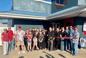 Cutting the ribbon for the new Italian restaurant Bella Donna's at Grand Lake and Danny's Dockside Pizza  was manager Jay Schraad with owners Libby Wright and Peter Florio. These restaurants were co-hosts with Honey Creek Landing Marina for a Grand Openin